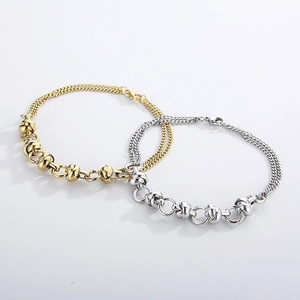 Detail of layered gold and silver stainless steel chains with interlocking link design