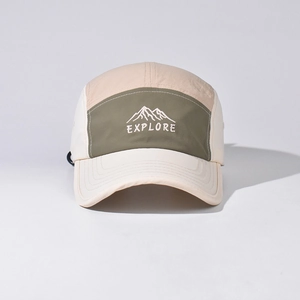Close-up of mountain peak embroidery and Explore text on multi-color nylon camping hat