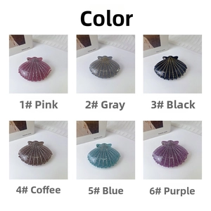 Detailed grid view of shell-shaped hair claws in six shimmering colors on white background