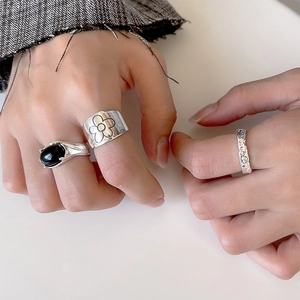 Set of three 925 silver rings with black onyx and floral engraving on model's hand