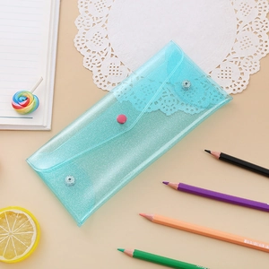 Detail of teal glitter stationery pouch with snap closure and iridescent translucent finish