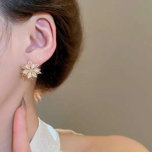 Detailed view of cat's eye stone flower earrings with sparkling zircon accents