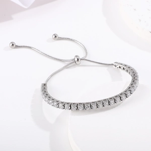 Detail of adjustable silver tennis bracelet with cubic zirconia and slide buckle mechanism