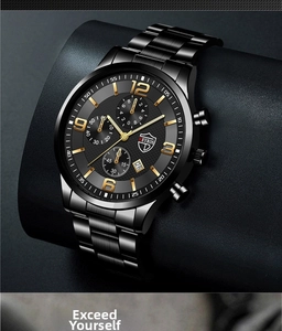 Close-up of black stainless steel watch with golden numerals and chronograph dial