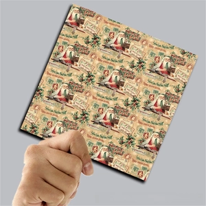 Close-up of vintage Santa Claus scrapbooking paper with retro stamp and letter patterns