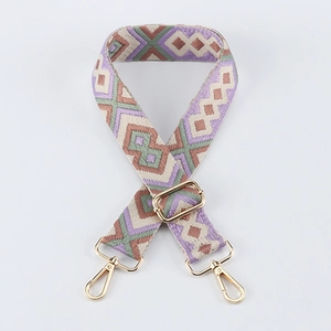 Detail of adjustable 38mm woven bag strap with geometric diamond patterns and gold buckles