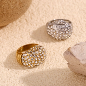 Macro shot of 18K gold and silver stainless steel rings with full crystal pavé detail
