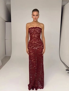 Detailweergave van de fijne kanttextuur en strapless halslijn van de wijnrode jurk