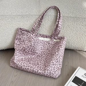 Close-up of purple leopard print tote bag showing thick fabric texture and handles