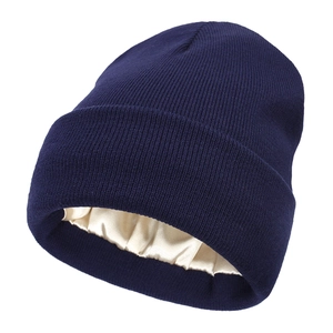 Close-up of the satin lining inside a navy knit beanie designed for hair protection