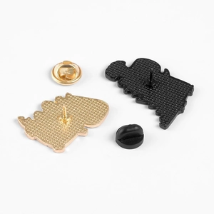 Detail of metal enamel pin backs showing butterfly clutch and rubber pin backings