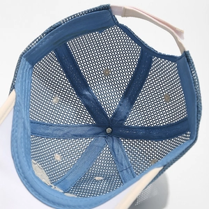Close-up of sky blue mesh baseball cap showing breathable net texture and inner structure