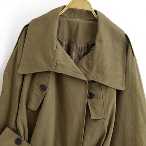 Women's army green utility jacket with navy collar and button details on white background