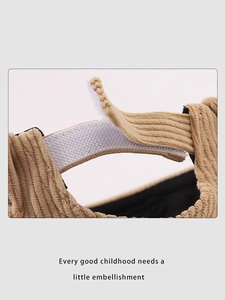 Detailed close-up of corduroy texture and adjustable velcro strap on child's hat