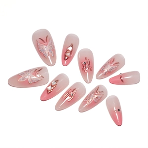 Blush gradient press-on nails with butterfly charms and pearls, 10-piece set.
