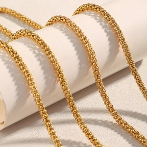 Macro shot of gold-plated woven chain showing detailed texture and high-gloss finish