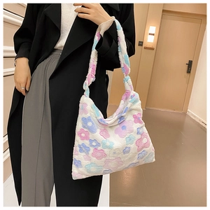 Close-up of soft plush tote bag with pink and blue floral pattern and fluffy shoulder strap