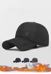 Close-up of quilted diamond texture and metal badge on thermal winter baseball cap