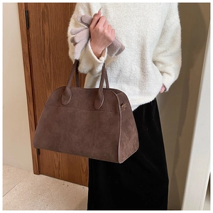 Detail of coffee brown matte suede tote bag featuring high-quality leather texture and handles