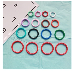 Close-up of assorted colorful 2.5cm lacquered metal spring rings and O-ring connectors