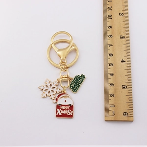 Golden Christmas keychain with Santa, snowflake and enamel charm measuring 9.5cm length
