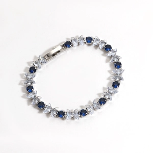 Detailed macro view of silver bracelet with marquise-cut blue and clear zircon stones