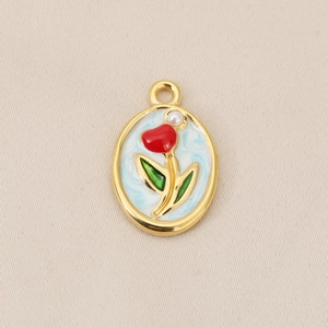 Macro detail of 18K gold plated oval tulip pendant with blue enamel and a tiny pearl