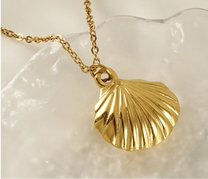 Macro view of gold shell pendant with radiating texture on an ice-crack glass base
