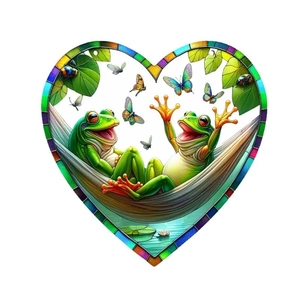 Detail of heart-shaped tree of life suncatcher featuring two frogs on a hammock
