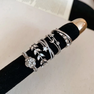 Detailed set of silver rings featuring floral, moon, and star designs with zircon stones