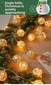 Detail of warm gold hollow geometric LED string lights on a Christmas tree branch