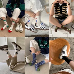 Korean style cotton mid-calf socks with various trendy prints shown in lifestyle shots