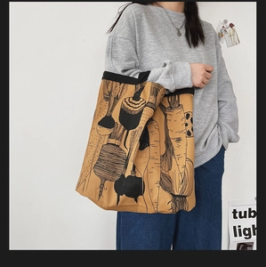 Detail of minimalist khaki canvas tote with vegetable illustration and black line art