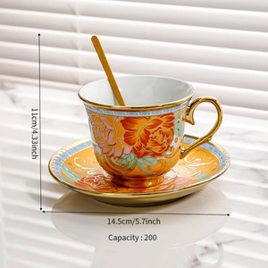 Detail view of orange floral ceramic coffee cup with gold spoon and size dimensions