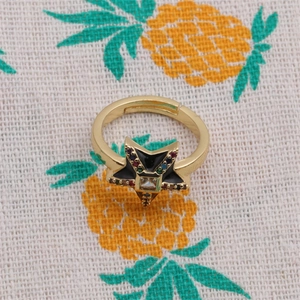 Macro view of adjustable star ring with colorful zircon stones on pineapple fabric