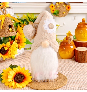 Detail of sunflower gnome doll featuring a fuzzy hat, white beard, and rustic decor