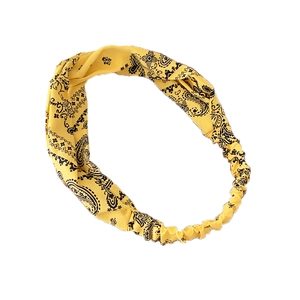Elastic wide headband with yellow paisley pattern cross-knot design on white background