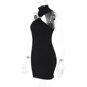 Detail of elegant black halter neck dress featuring a stylish gold metal ring connector