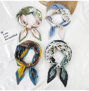 Detail of pleated silk scarves with four distinct floral and geometric patterns for women