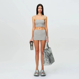 Two-piece grey fitted set with crop top and mini skirt featuring cross patterns