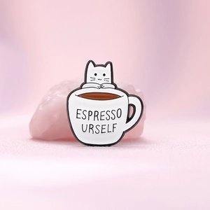 Creative enamel cat in coffee cup pin with Espresso Urself text on pink background