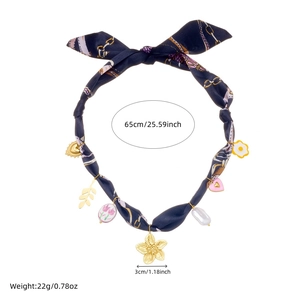 Detail view of scarf necklace with golden pendants, pearls and precise dimensions