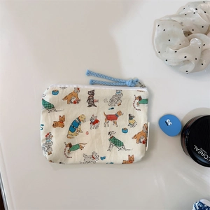 Close-up of floral beige cotton coin purse with cute puppy print and blue zipper pull