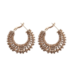 Elegant gold-tone hoop earrings with multiple rows of sparkling pavé rhinestones on white back