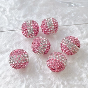 Macro shot of sparkling pink gradient rhinestone balls for DIY jewelry and phone charms