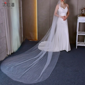 Detail of a white long cathedral bridal veil showing soft tulle texture and elegant drape
