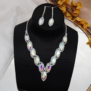 Macro shot of silver bridal jewelry set with iridescent marquise crystals on black velvet