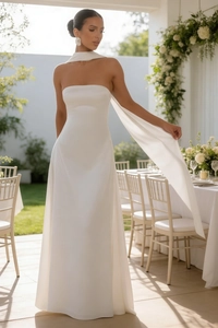 Detail of elegant white strapless evening gown with matching flowing neck scarf accessory