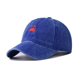 Detailed view of red crab embroidery on navy blue washed cotton baseball cap