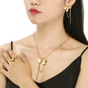 Detail of gold bow jewelry set with sparkling crystals and elegant chain tassels